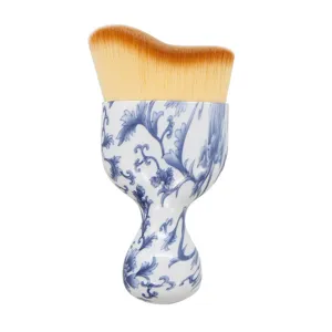 Close-up detail of the wave top makeup brush featuring blue and white porcelain handle.