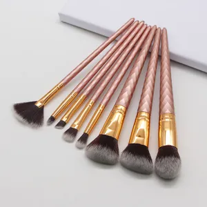 Detail view of 8-piece rose gold makeup brush set with soft bicolored bristles and textured handles.