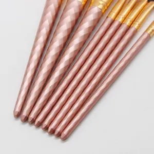 Detail of rose gold spiral makeup brush set handle, showcasing elegant design and finish.