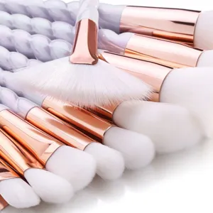 Detailed view of 10-piece unicorn makeup brush set with twisted handles and soft white bristles.