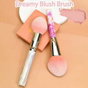 Close-up detail of soft makeup blush brush with unique marble pattern handle for smooth blending.