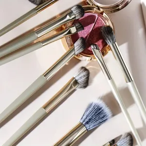 Close-up detail of 13-piece gilt eye makeup brush set with soft bristles and golden ferrule.