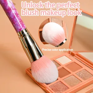 Marble handle makeup brush detail showing soft fluffy bristles and precise blush application.