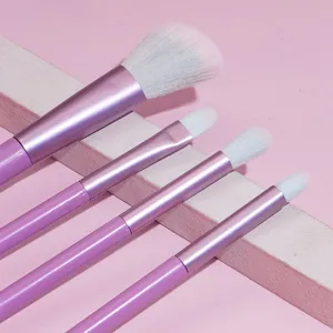 Detailed view of pink makeup brush set with soft synthetic bristles and metallic handles.