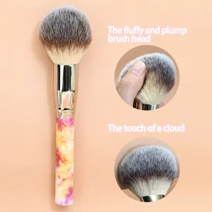 Large fluffy makeup brush with marble handle and soft synthetic bristles for easy powder.