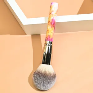 Large soft makeup powder brush with colorful marble handle for professional cosmetic use.