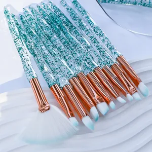 Detailed close-up of crystal glitter makeup brushes with soft bristles and rose gold ferrules.