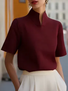 Detail shot of a burgundy mandarin collar short sleeve shirt with unique split neck.