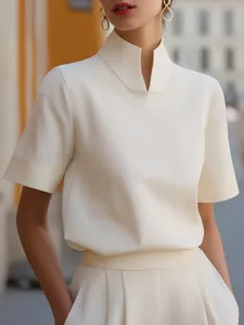 Close-up detail of the elegant white short sleeve stand collar blouse with unique slit design.