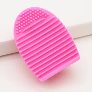 Pink silicone makeup brush cleaner detail, showing textured scrubbing surface for deep cleaning.