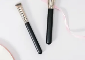 Detailed close-up of professional makeup brushes with soft dense bristles and sleek handles.