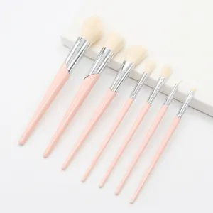 Detailed view of the pink makeup brush set showing soft bristles and sleek slanted metal handles.