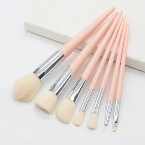 7-piece pink makeup brush set featuring soft bristles and slanted ferrules for flawless application.