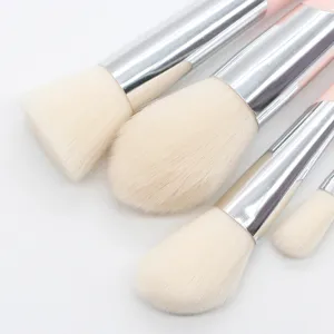 Close up detail of soft bristle pink makeup brushes set with silver ferrules for flawless blending.