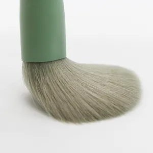 Close up of matcha green makeup brush soft dense bristles detail shot beauty tool accessory