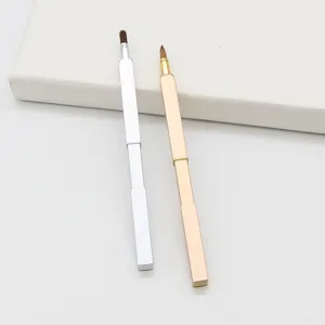 Portable retractable lip brush detail closeup, metal casing makeup tool for lipstick.