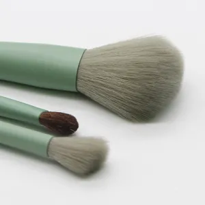 Close-up view of soft bristles and matcha green wooden handle makeup brush details.