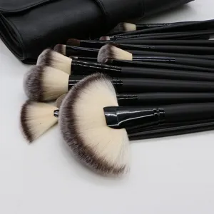 Detailed close-up view of soft black makeup brush bristles and smooth handle texture.