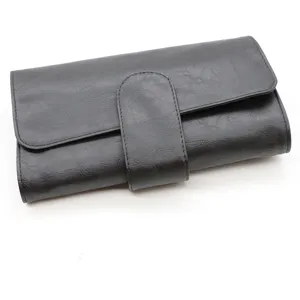 Black PU leather makeup brush roll bag detail, professional cosmetic tool storage organizer case.
