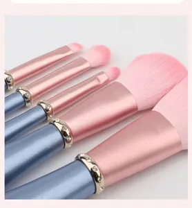 5-piece pink diamond makeup brush set with blue handles and sparkling rhinestone ferrules.