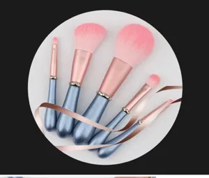 5-piece pink makeup brush set with rhinestone blue handles and soft bristles for detailed use.