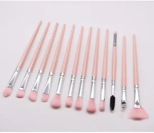 12-piece pink makeup brush set, detail view of soft nylon bristles and plastic handles.