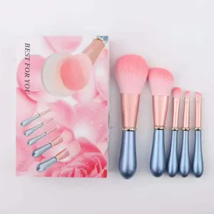 5-piece pink makeup brush set with sparkling rhinestone bands, blue handles and soft bristles.