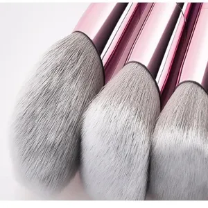 Nahaufnahme der weissen synthetischen Pinselhaare mit metallisch rosa Zwingen Details.