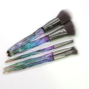 Detail shot of diamond cut crystal handle makeup brushes set with soft bristles and metal ferrule.