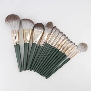 Detail view of 14-piece makeup brush set with green handles and soft dual-color bristles.
