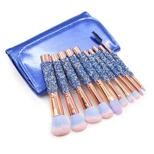 Detailed closeup view of 10-piece rhinestone makeup brush set with shiny blue storage pouch.