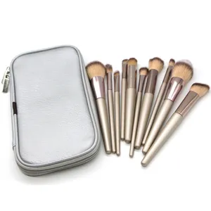Champagne makeup brush set detail view showing soft bristles and sleek metallic handles.