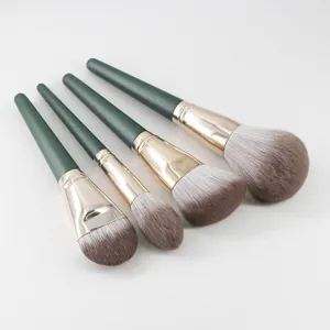 Detail view of professional makeup brush set with soft gradient bristles and green handles.
