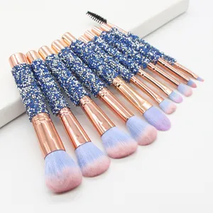 Close-up details of the 10-piece rhinestone makeup brush set with gradient blue pink bristles.