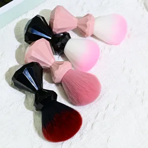 Detail shot of four diamond-handle makeup brushes with soft gradient bristles for beauty.