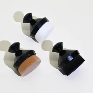 Close-up detail of professional diamond foundation makeup brushes with soft dense bristles.