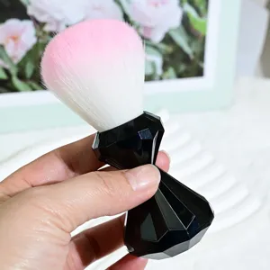 Detailed view of soft bristle makeup brush with black diamond handle for blush and powder.