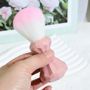 Pink diamond handle makeup brush with soft gradient bristles for blush and nail dust.