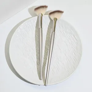 Set of 2 soft fan makeup brushes for highlighter facial detailing and powder makeup application.