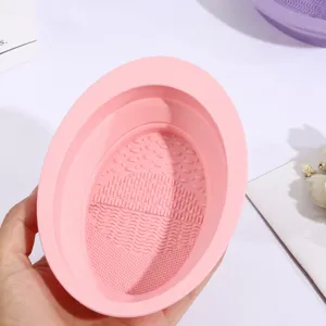 Silicone makeup brush cleaning bowl detail, foldable design with textured washing pads.