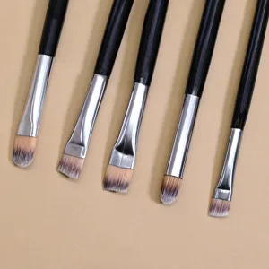 Black handle makeup brush detail shot showcasing soft bristles and silver metal ferrule.