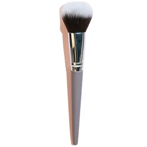 Professional makeup powder brush with soft dual-color bristles and ergonomic grey handle.