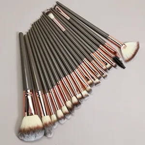 Close-up detail of soft bristle makeup brush set with elegant brown handles and rose gold ferrule.