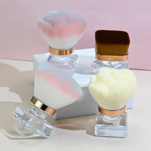 Detailed shot of rose-shaped and flat makeup brushes featuring clear crystal handles and soft bristles.