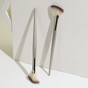 Detail shot of silver handle fan makeup brush, soft bristles for highlighters.