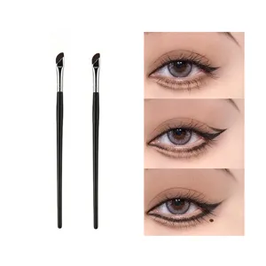 Detailed view of angled eyeliner and eyebrow makeup brushes with precision bristles for fine lines.