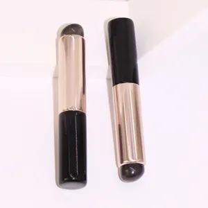 Detalle de primer plano pincel labios silicona, herramienta maquillaje doble extremo metal.