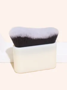Close-up detail of dense wave-shaped foundation brush bristles and sleek white base handle.