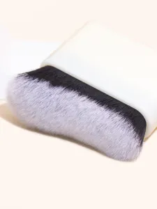Close-up detail of the wide flat foundation brush with soft bristles and white base.