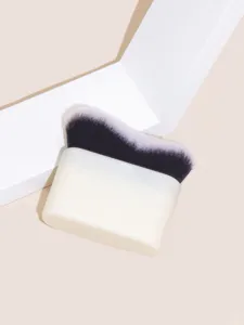 Wave foundation brush detail shot showing dense dual-color bristles and ergonomic white handle base.